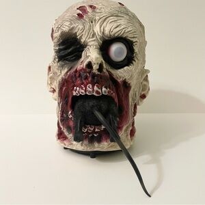 Zombie Head Eating A Rat Halloween Decoration Flaws